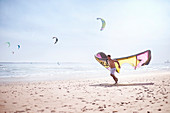 Man running with kiteboarding kite