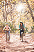 Mother and daughter bike riding on path