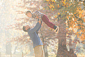 Father lifting son overhead