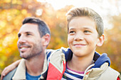 Close up smiling father and son hugging