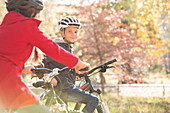 Portrait boy bike riding in autumn park