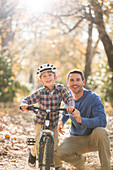 Father teaching son to ride a bike