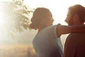 Couple hugging outdoors