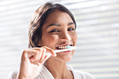 Close up Woman brushing teeth