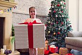 Girl holding large Christmas gift