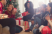 Woman shaking Christmas gift