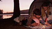 Young couple in camping tent