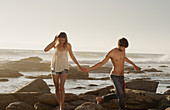 Young couple holding hands and walking