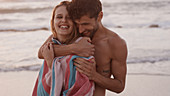 Young couple hugging on beach