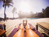 Woman sunbathing at sunny poolside