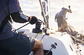 Man holding sailing rigging on sailboat