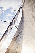 Sailboat sail against sunny sky