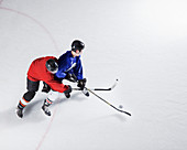 Hockey players going for puck on ice