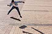 Boy flipping skateboard