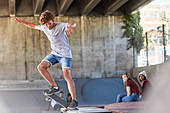 Boy doing skateboard stunt at skate park