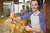 Man shopping for oranges in market