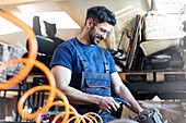 Metal worker using equipment in workshop