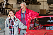Father and son next to classic car