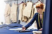 Female tailor cutting fabric