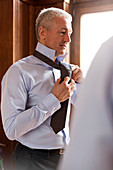 Businessman trying on tie