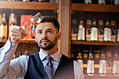 Bartender examining whiskey