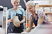 Senior woman holding pottery
