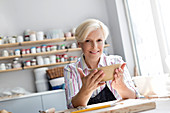 Mature woman holding bowl