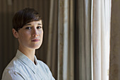 Brunette woman at window