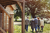 Friends walking outside lakeside cabin