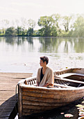 Serene woman sitting in canoe