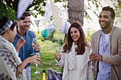 Smiling friends drinking champagne