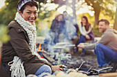 Woman with friends at campfire