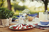 Caprese salad appetizer on patio table