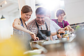 Couple enjoying cooking class kitchen