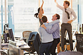Business people celebrating and jumping in office