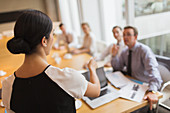 Businesswoman leading meeting in conference room