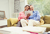 Smiling mature couple using digital tablet