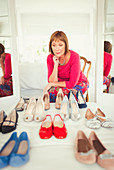 Mature woman deciding which shoes to wear