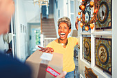 Woman receiving package delivery at front door