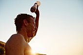 Tired runner pouring water on head