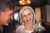Portrait smiling senior couple drinking white wine