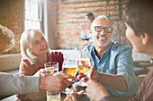 Couples toasting beer and wine glasses
