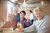 Portrait smiling couples drinking beer