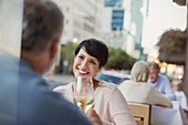 Smiling couple toasting white wine glasses