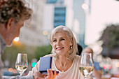 Smiling senior woman receiving jewellery gift