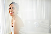 Portrait smiling woman wrapped in towel