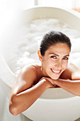 Portrait smiling woman enjoying bubble bath