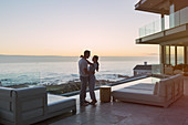 Affectionate couple hugging on luxury patio