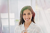 Portrait smiling brunette woman drinking water