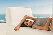 Woman relaxing laying on chaise lounge